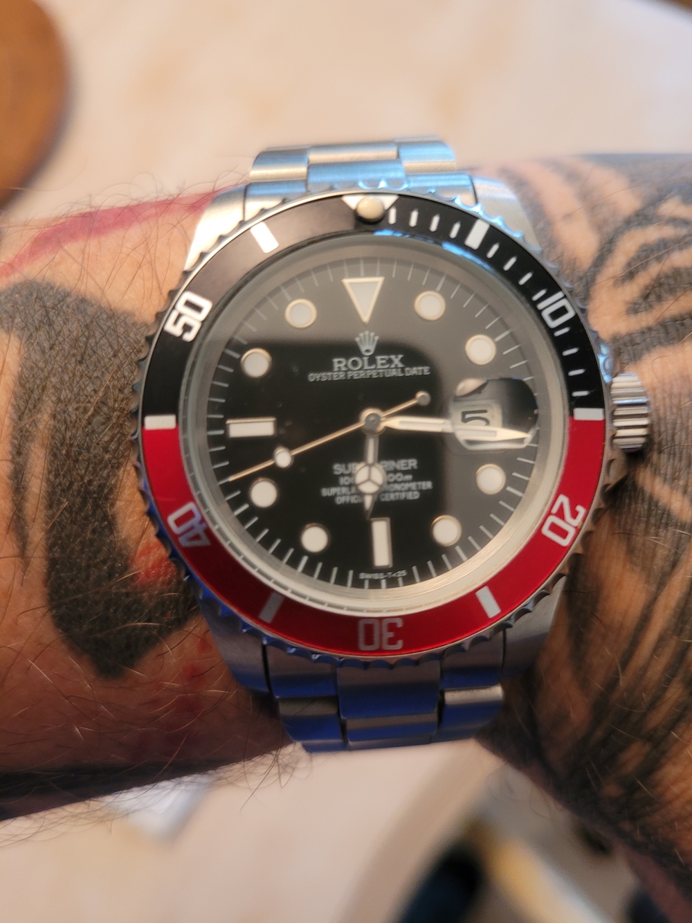 Rolex Black Dial Watch with Red and Black Bezel